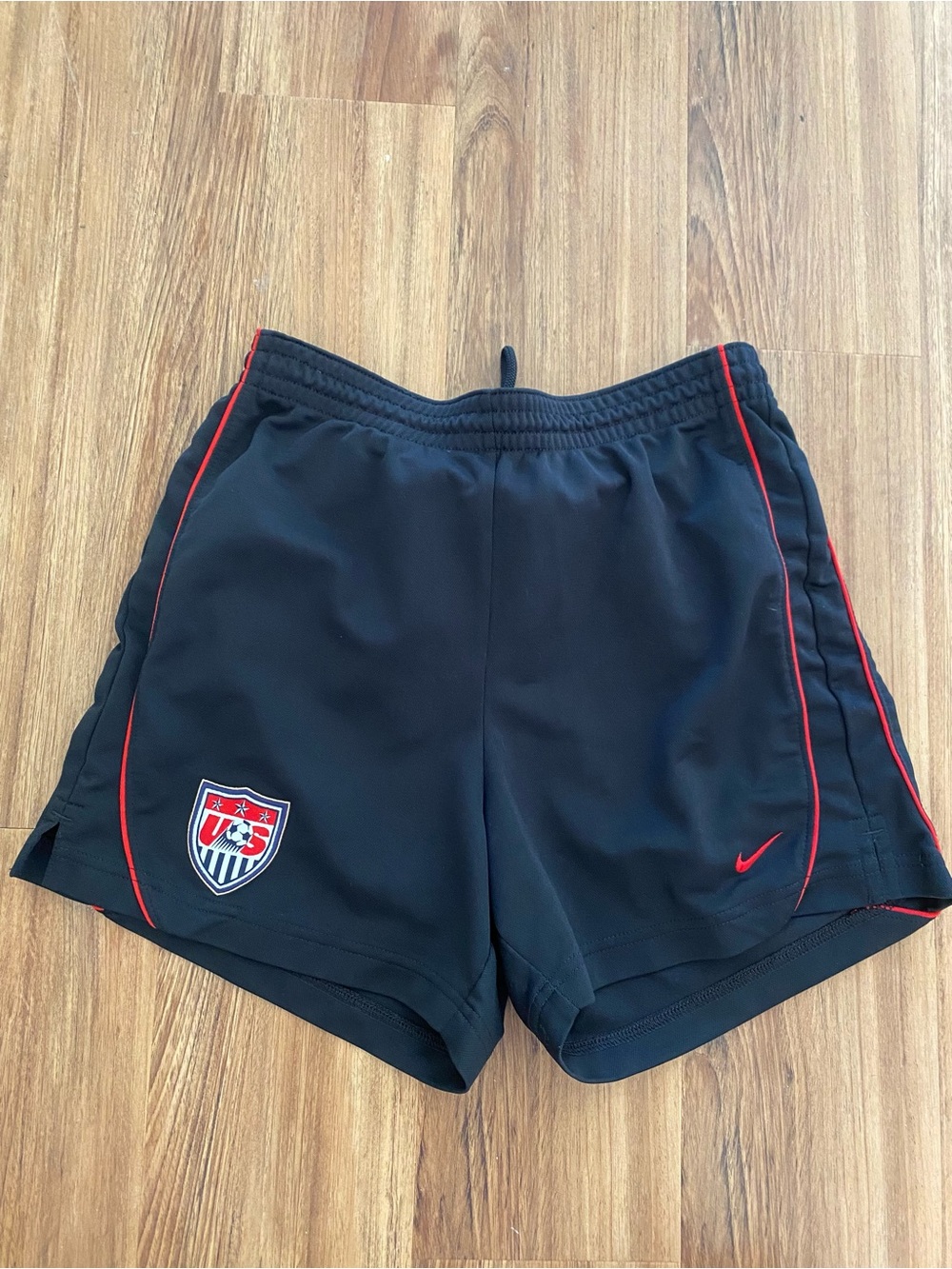 Nike Women's Black Athletic Shorts with Red Trim and Crest